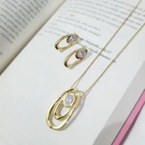 conjunto ouro oval com ponto de luz no meio