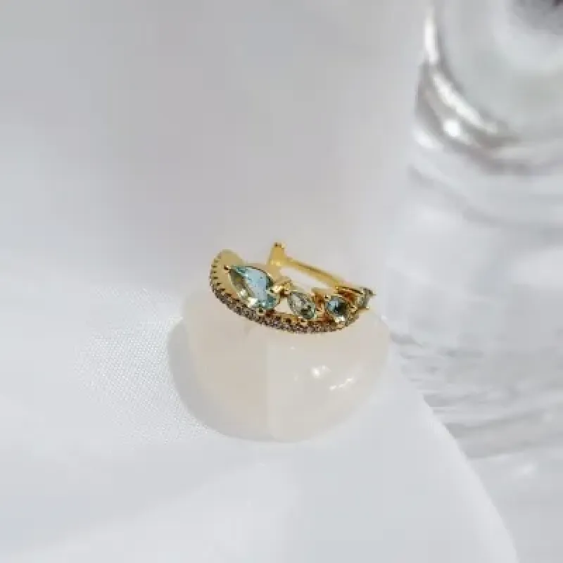 piercing ouro fileira zirconias 4 gotinhas azul