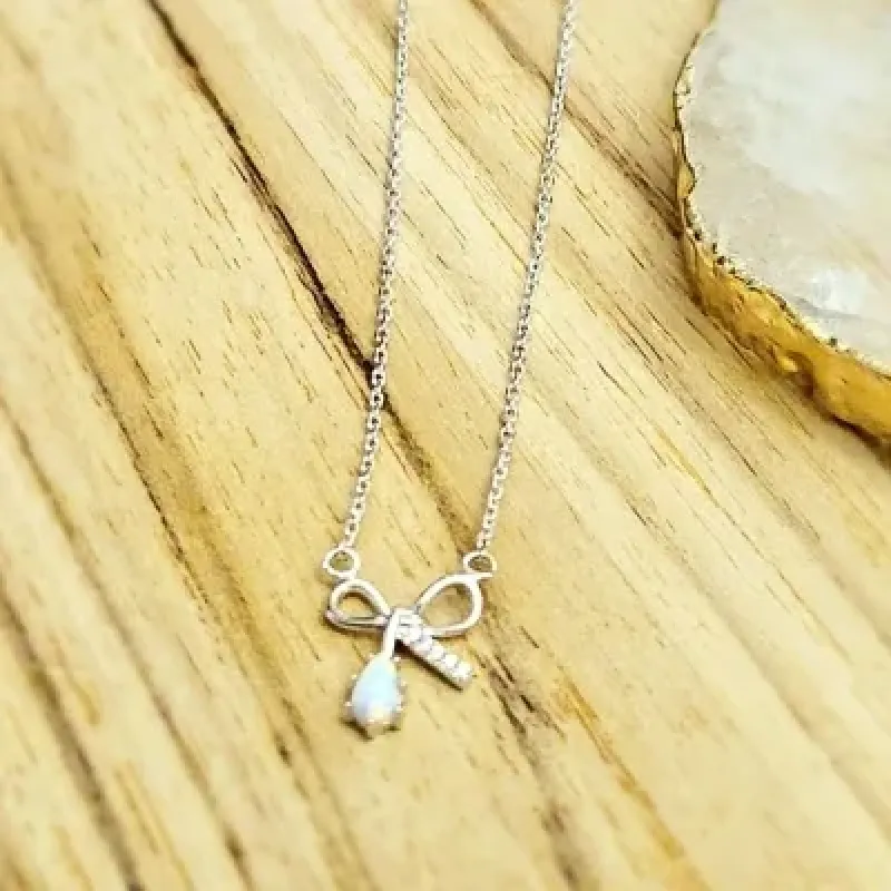 colar rodio laço com uma ponta zirconias e outra gota branca