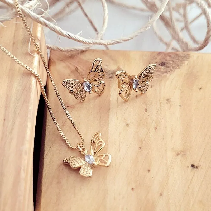 conjunto ouro borboleta com ponto de luz no meio