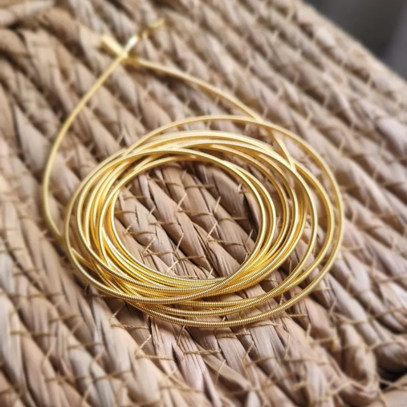 pulseira ouro corda de violão