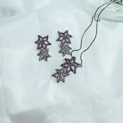 conjunto ródio negro com duas flores cravejadas zircônias rosa e lilás